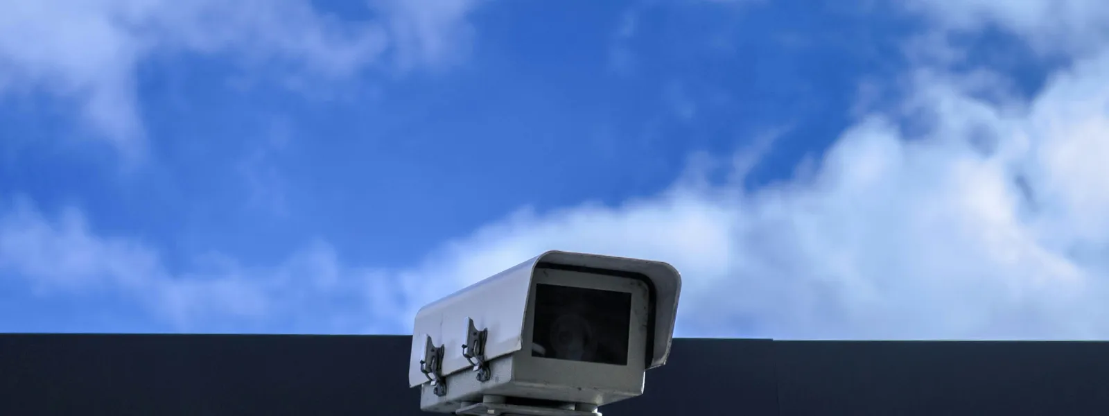 Security camera against blue sky symbolizing website tracking and surveillance